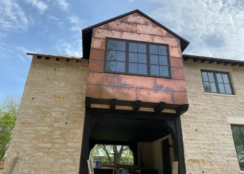 Copper metal panel facade on a stone building for Skylight Installation in Fairfield Plantation