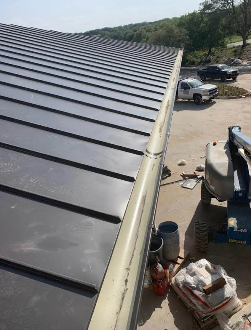 Standing seam panel and gutter detail on a metal roofing jobsite in Fairfield Plantation
